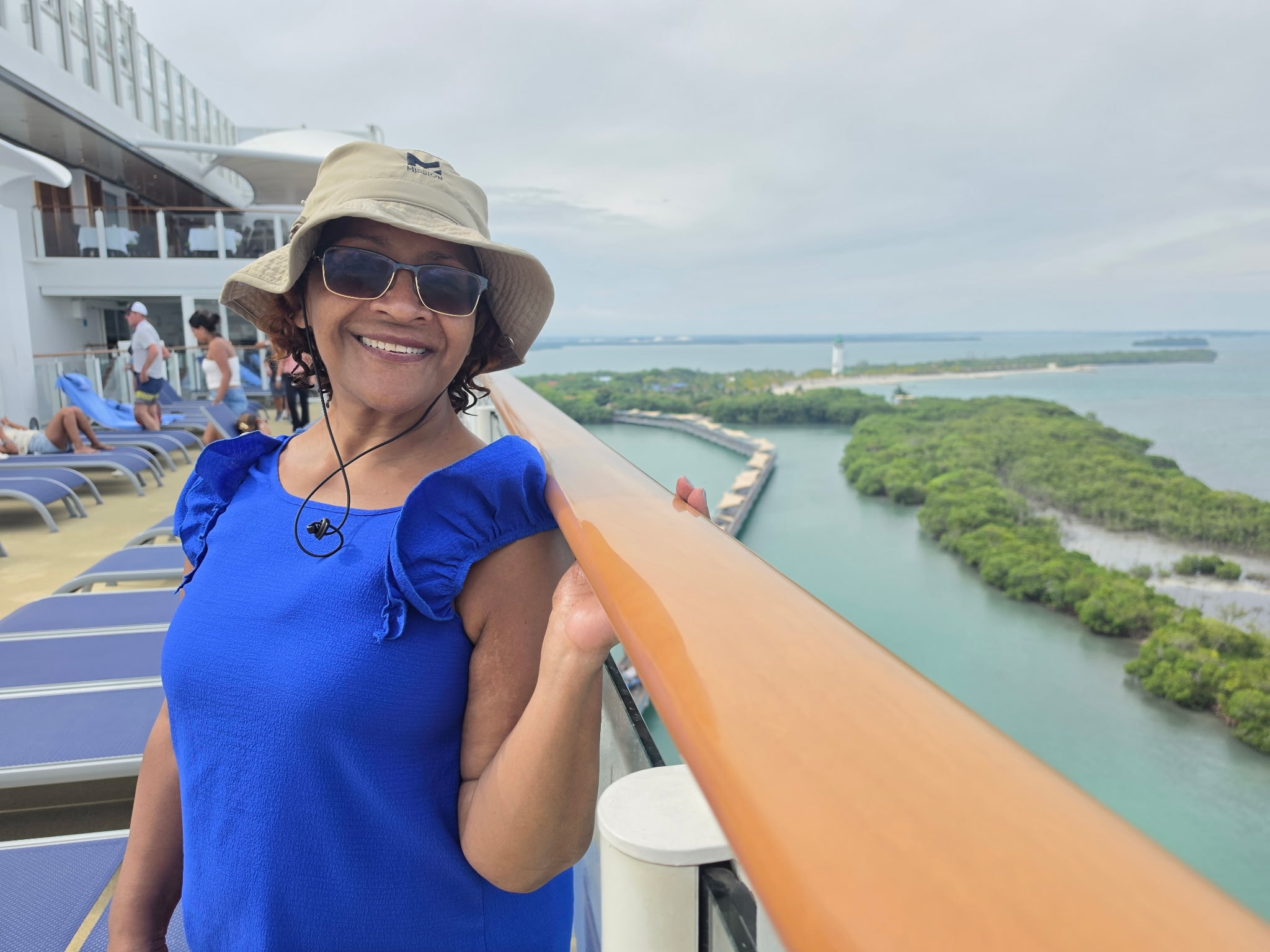 Jean on a cruise ship deck with scenic coastal views